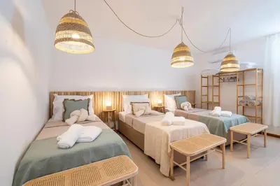 a bedroom with two beds and two tables at Alma Invicta Albufeira in Albufeira