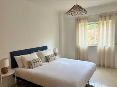 a bedroom with a large white bed with a window at SummerSalt Apartment - Albufeira Old Town in Albufeira