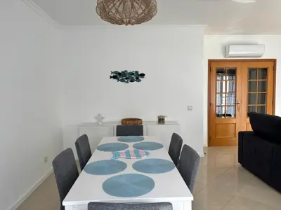 a dining room with a white table and chairs at SummerSalt Apartment - Albufeira Old Town in Albufeira