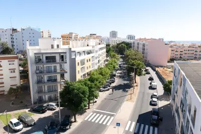 an aerial view of a city street with parked cars at Modern 2BR Quarteira Apartment in Quarteira