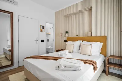 a bedroom with a bed with towels on it at Urban Bliss Boutique Guesthouse in Faro