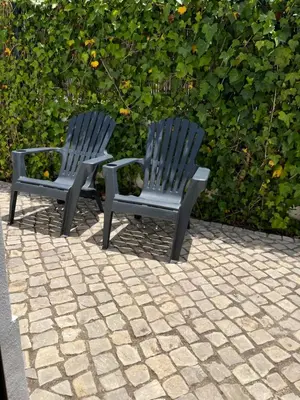 two blue chairs sitting next to each other on a patio at Pátio da Várzea in Albufeira