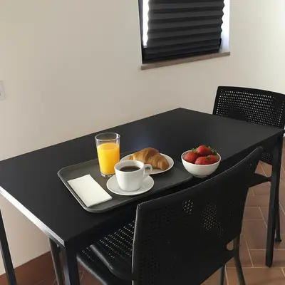 a black table with a tray of food and a plate of fruit at Pátio da Várzea in Albufeira