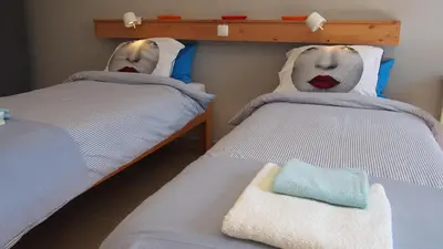 two twin beds with faces on them in a room at B&B Casa Encantada in Boliqueime