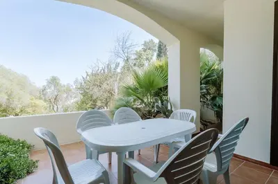a white table and chairs on a balcony at Apartment Green Oasis in Albufeira Jardim mit Pool in Albufeira
