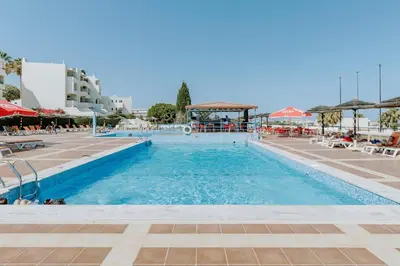 a large swimming pool with blue water in a resort at Apartment Green Oasis in Albufeira Jardim mit Pool in Albufeira