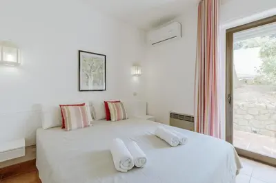 a white bedroom with a bed with towels on it at Apartment Green Oasis in Albufeira Jardim mit Pool in Albufeira