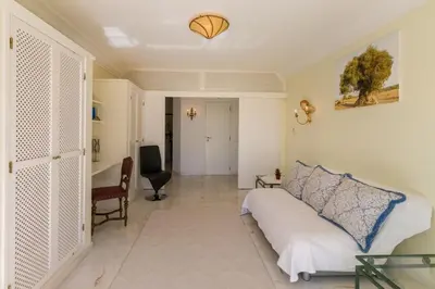 a bedroom with a bed and a desk in it at Traumhaft schöne Villa mit Pool und Meerblick in Albufeira