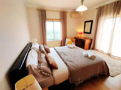 a bedroom with a bed with two pillows on it at Sol Mar Penthouse by Da Costa in Albufeira