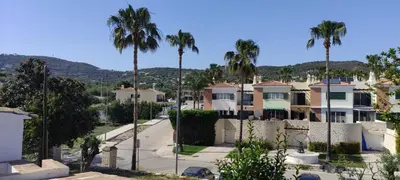 a white building with brown doors and windows at Laranjeira 2 by AlmaAlgarvia in Santa Bárbara de Nexe