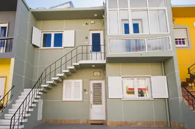 an apartment building with stairs and a door at Casas Sao Luis in Faro