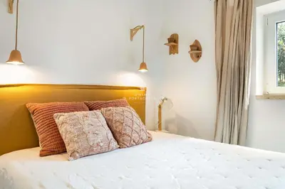 a bedroom with a bed with two pillows on it at Casa Bela Mar in Albufeira