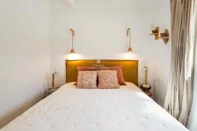 a bedroom with a white bed with two pillows at Casa Bela Mar in Albufeira