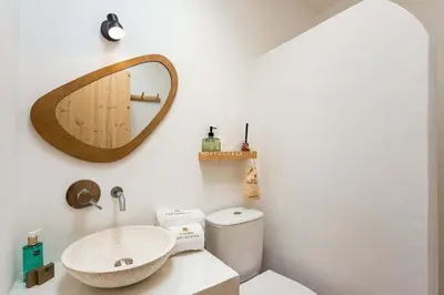 a bathroom with a sink and a mirror on the wall at Casa Bela Mar in Albufeira