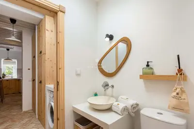 a bathroom with a sink and a mirror on the wall at Casa Bela Mar in Albufeira