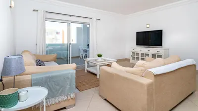 a living room with two couches and a tv at Falesia Marina in Quarteira