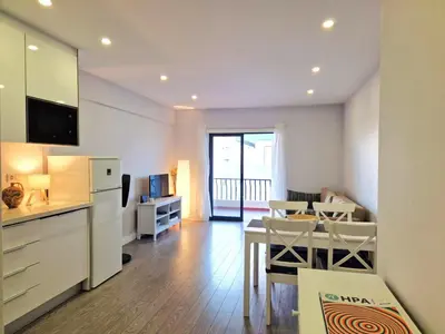 a living room with a kitchen and a dining room at Quarteira flat AC balcony and view in Quarteira