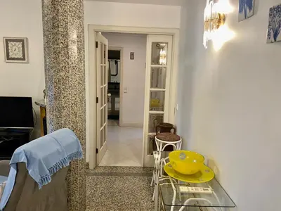 a small living room with a table and a hallway at Vila Lusa Marina in Vilamoura