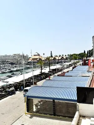 a row of blue roofs on a building with a marina at FM Marina Vilamoura in Quarteira