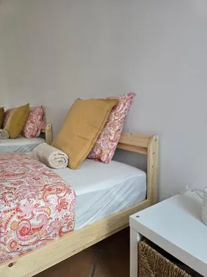 two beds with pillows on them in a room at Casa Alfazema in Faro