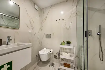 a bathroom with a shower and a toilet and a sink at Stay Apartment in Faro