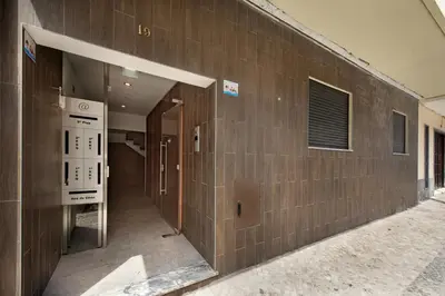 a building with a brick wall with an empty hallway at Stay Apartment in Faro