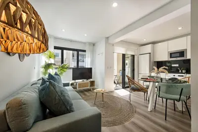 a living room with a couch and a dining room at Stay Apartment in Faro