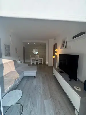 a living room with a couch and a flat screen tv at Modern apartment in Al-sakia Village in Quarteira