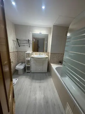 a bathroom with a sink and a tub and a toilet at Modern apartment in Al-sakia Village in Quarteira