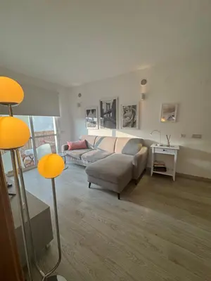 a living room with a couch and a table at Modern Apartament in Al-sakia Village in Quarteira