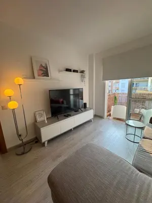 a living room with a large flat screen tv at Modern Apartament in Al-sakia Village in Quarteira