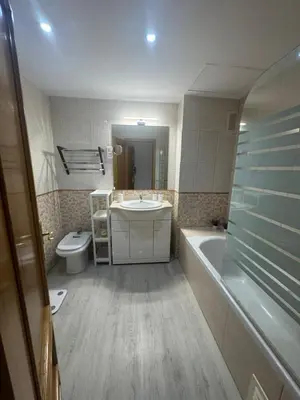 a bathroom with a sink and a tub and a toilet at Modern Apartament in Al-sakia Village in Quarteira