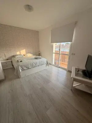 a bedroom with a bed and a television in it at Modern Apartament in Al-sakia Village in Quarteira