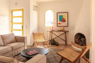 a living room with a couch and a fireplace at Aldeamento Aldeia do Golf V3 in Vilamoura