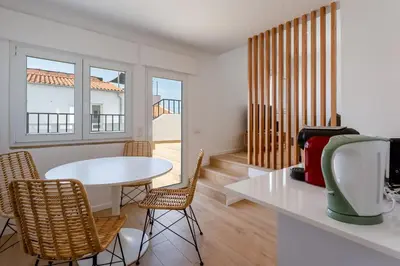 a living room with a white table and chairs at Modern 1BDR with Sea View in Albufeira by LovelyStay in Albufeira