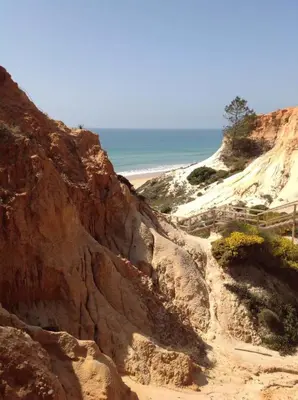 a rocky beach with the ocean in the background at 2 bedroom Apartment Falésia Beach in Albufeira