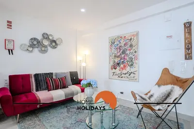 a living room with a couch and a chair at #317 Edificio Linda Vista by Home Holidays in Albufeira