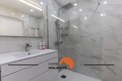 a bathroom with a shower and a sink and a mirror at #317 Edificio Linda Vista by Home Holidays in Albufeira