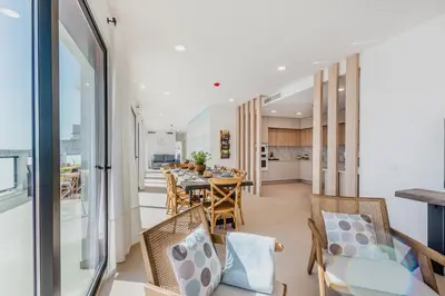 a kitchen and dining room with a table and chairs at Terra X Apartments in Faro