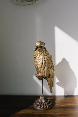 a statue of a bird sitting on a table at Terra X Apartments in Faro