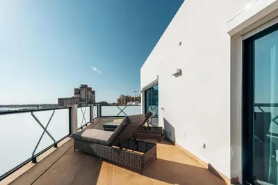 an apartment balcony with a view of the city at Terra X Apartments in Faro
