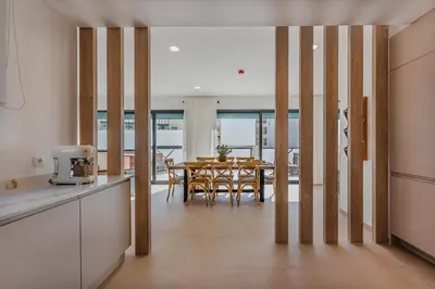 a kitchen and dining room with a table and chairs at Terra X Apartments in Faro