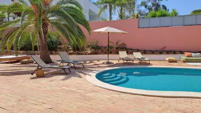 a dining room with a wooden table and chairs at La Balaia - charm and comfort 12 people 9 beds in Albufeira