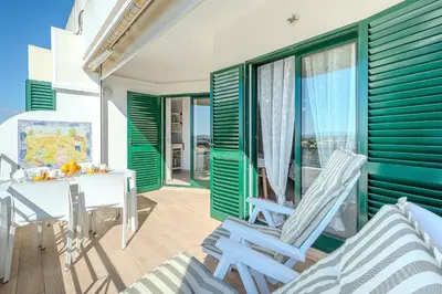 a patio with two chairs and a table on a balcony at Salgados Sunset and Sea View Apartment in Guia