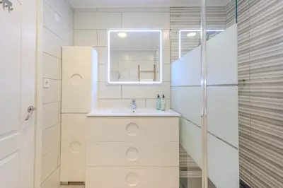 a white bathroom with a sink and a mirror at Salgados Sunset and Sea View Apartment in Guia