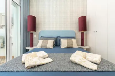 a bedroom with a blue bed with two pillows at Casa Bella in Faro