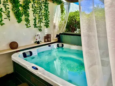a hot tub in a backyard with a window at Villa SOLAR DO MONTE 5 in Albufeira