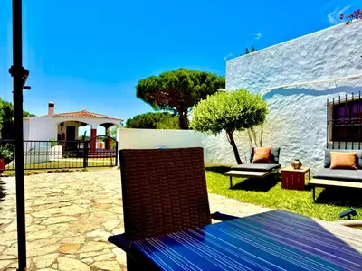 a patio with a bench and chairs in a yard at Villa SOLAR DO MONTE 5 in Albufeira