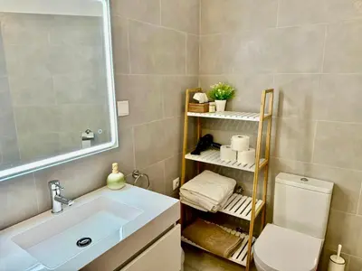 a bathroom with a sink and a toilet and a mirror at Villa SOLAR DO MONTE 5 in Albufeira