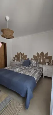 a bedroom with a large bed with blue sheets at Quinta Do Vale 32 by AL in Guia